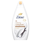 A 450ml bottle of Dove Calming Caring Bath Moisturising Cream, with shea butter, soothing vanilla scent, and a white and gold design with vanilla beans on the label.